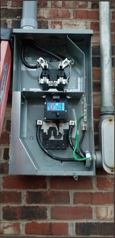 Harrison & Sons Electrical — new exterior meter service disconnect with main breaker opened on brick wall