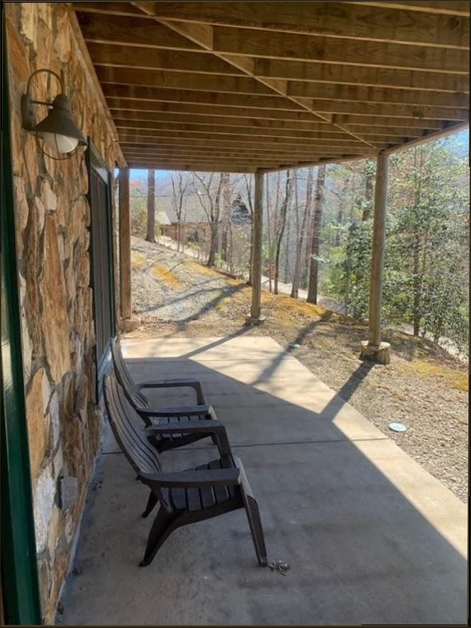 Harrison & Sons Electrical — gooseneck barn-style porch light mounted on a stone exterior